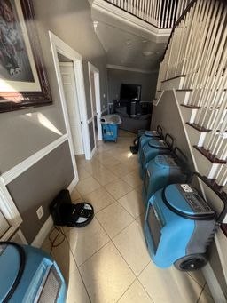 Drying equipment staged along a hallway on a Mr. Restoration job